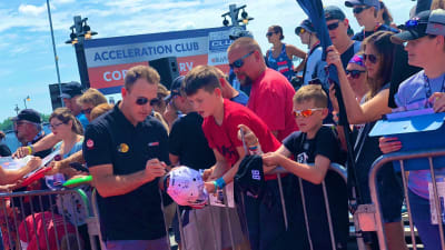 Daniel Hemric signs autographs for young NASCAR fans on his way into the driver/crew chief meeting Sunday at Michigan International Speedway.