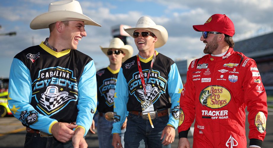 Austin Dillon walks with members of the Carolina Cowboys rodeo team at the track
