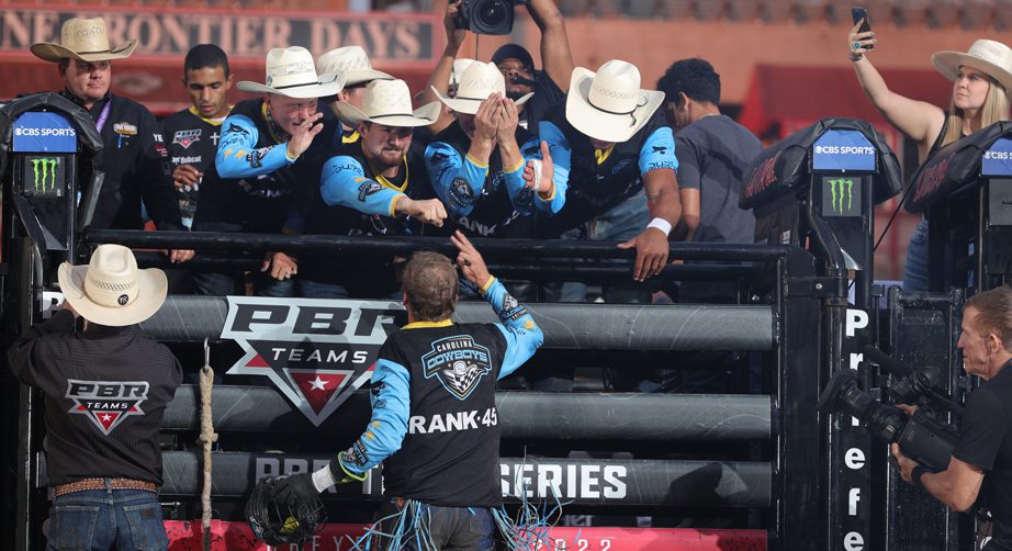 Teammate congratulate a Carolina Cowboys member who just rode