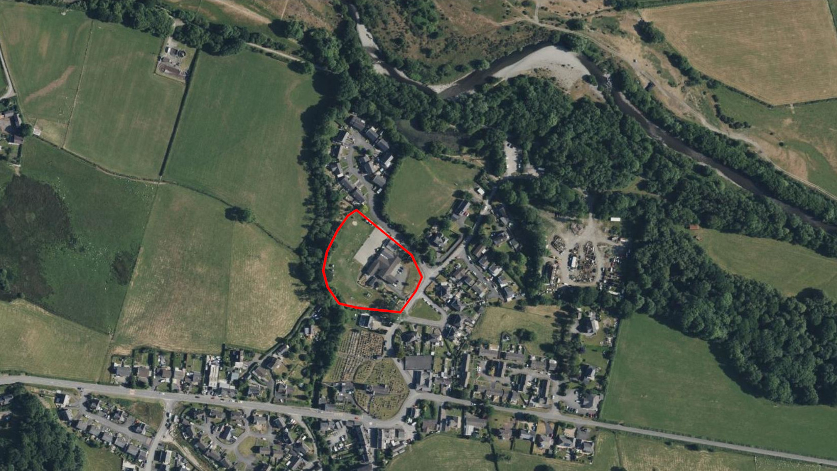 Satellite photo showing the location of the school just south of the pond, cycleway and river