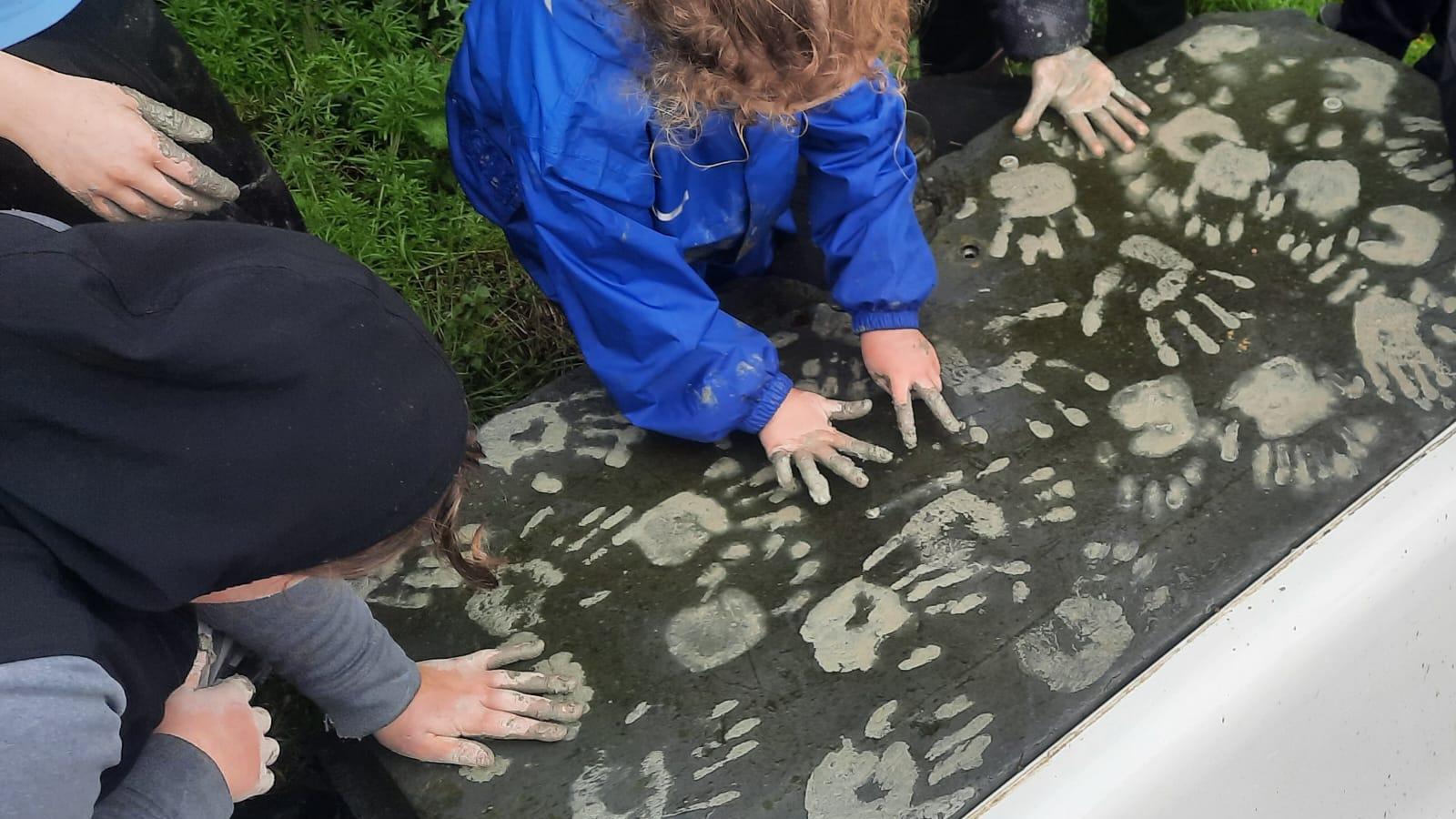 Clay hand prints on slate table