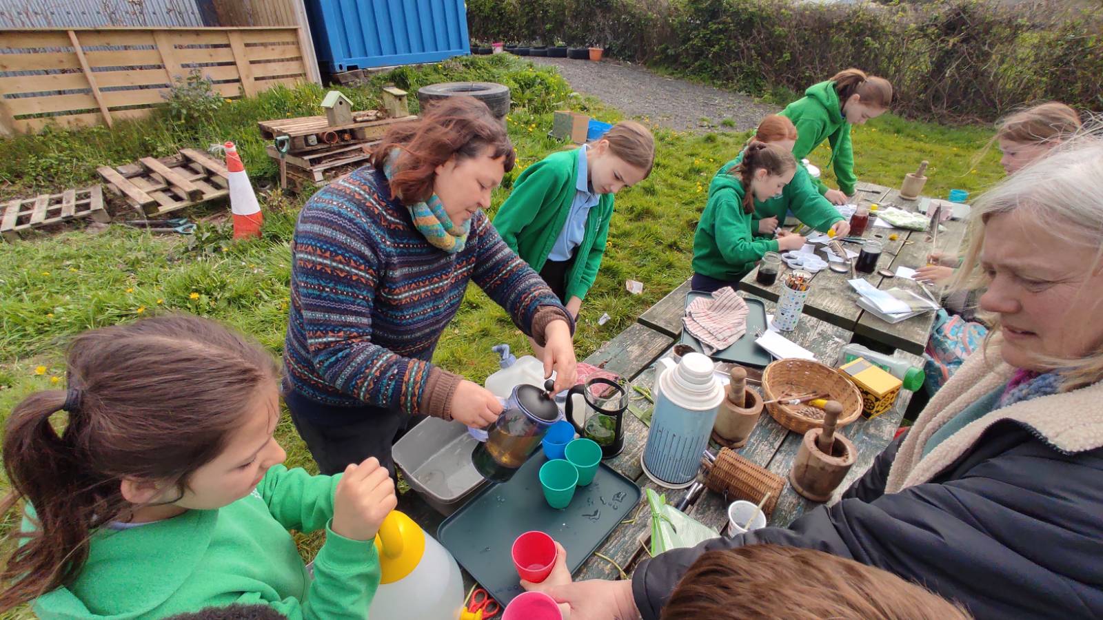 Jo pouring out the herbal teas for the students to taste.