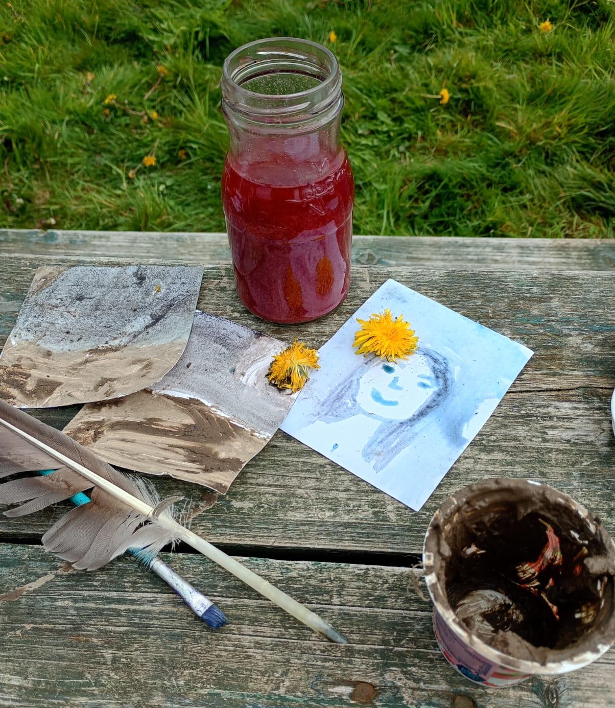 Pictures painted with dyes, clay and flowers.