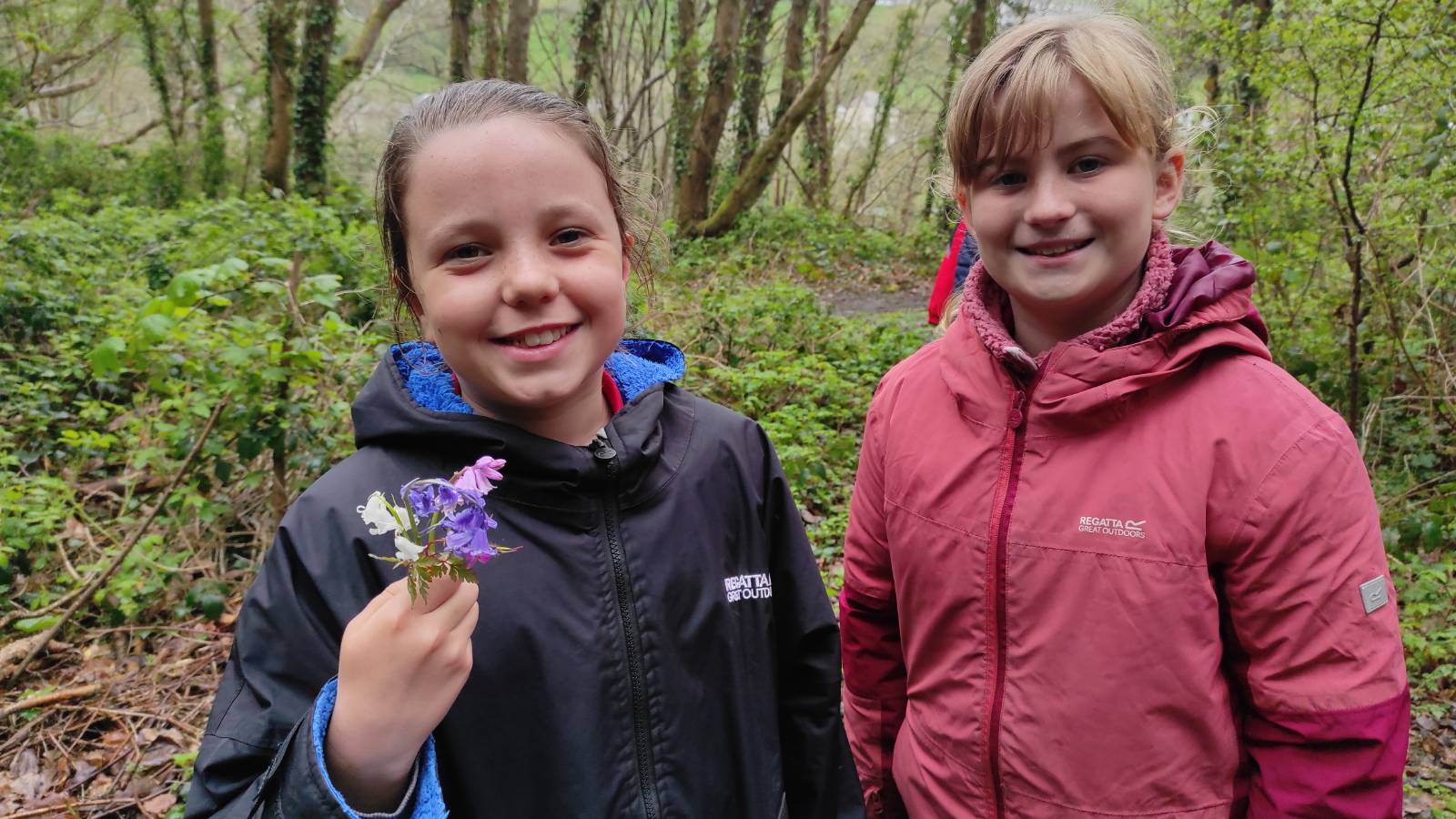 Student with posy of Blubell and Stinky Bob.