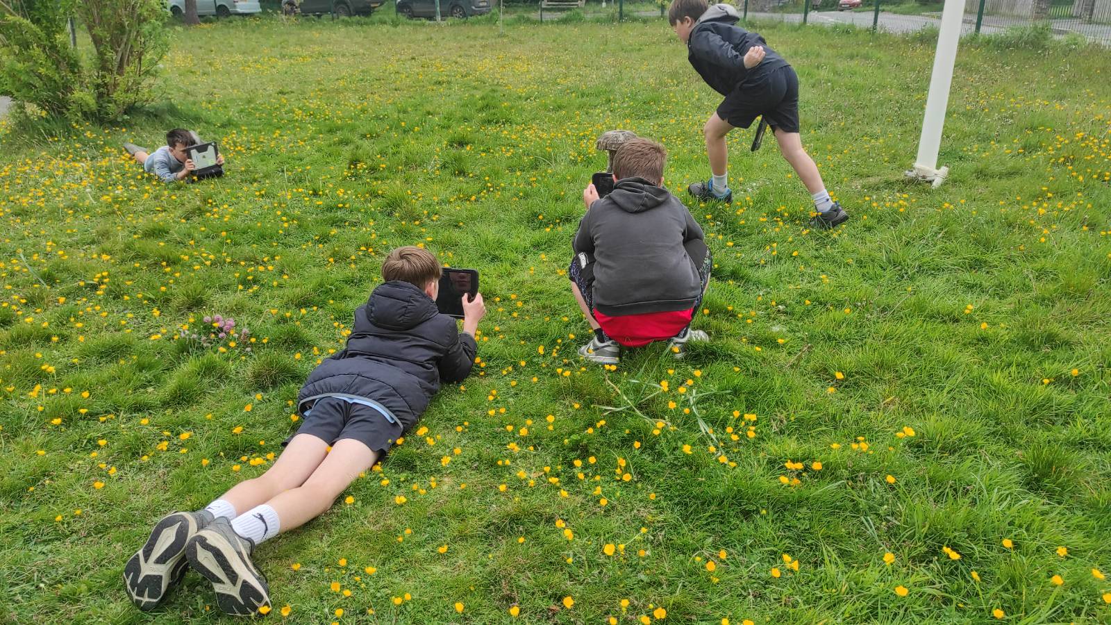 Students taking photos of a mushroom sculpture, to use as a background texture for a cyanotype print.