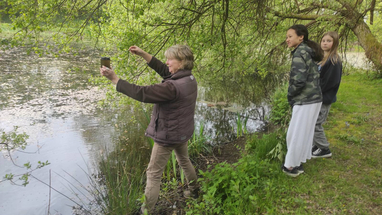 Sheena pond dipping with students (very clear with no visible invertebrates!)