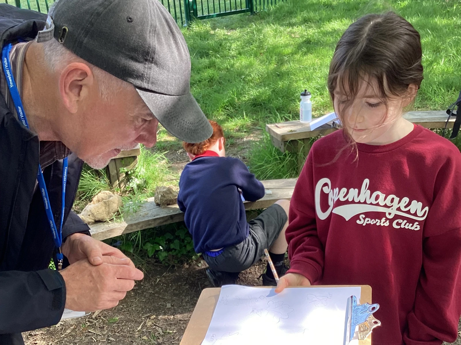 Student showing Jake her intricate & detailed drawings