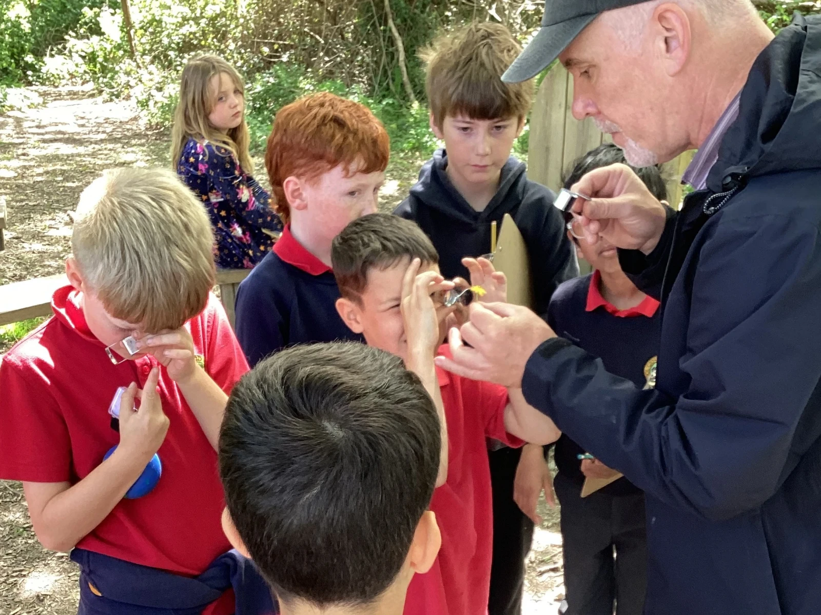 Jake showing students how to use a hand lens