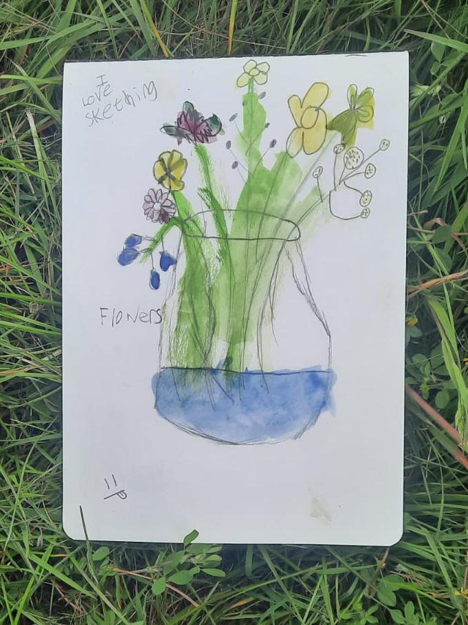 Still life of wildflowers in vase, on the grass