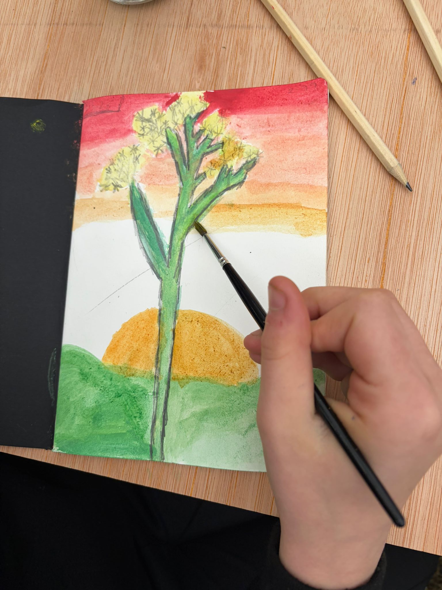 Painting a Cowslip in front of a sunset
