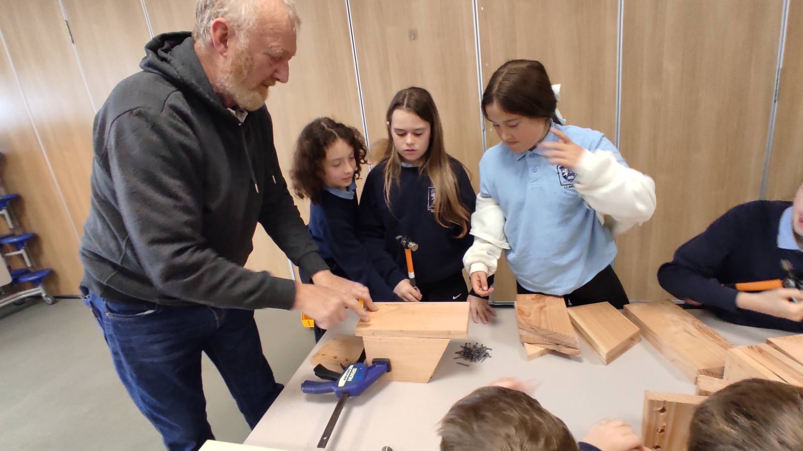 Harry showing students how to line up the back of the nestbox