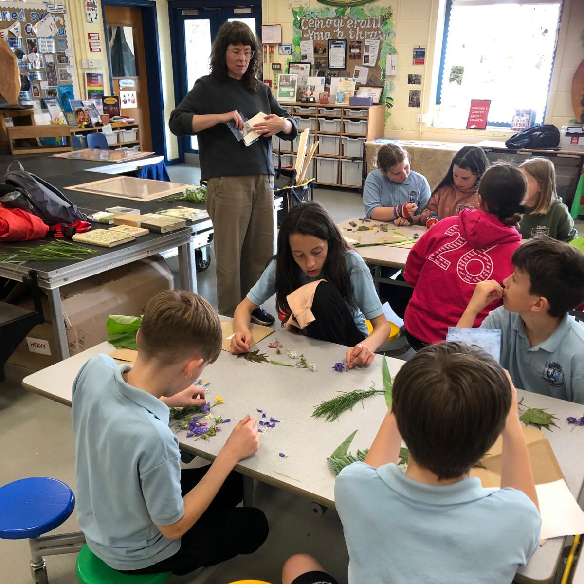 Students sat at communal desk sorting through plant material