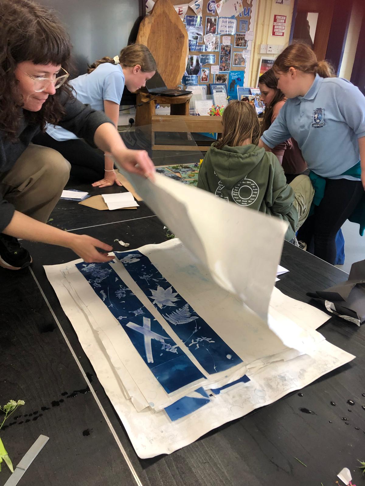 Artost uncovering cyanotypes