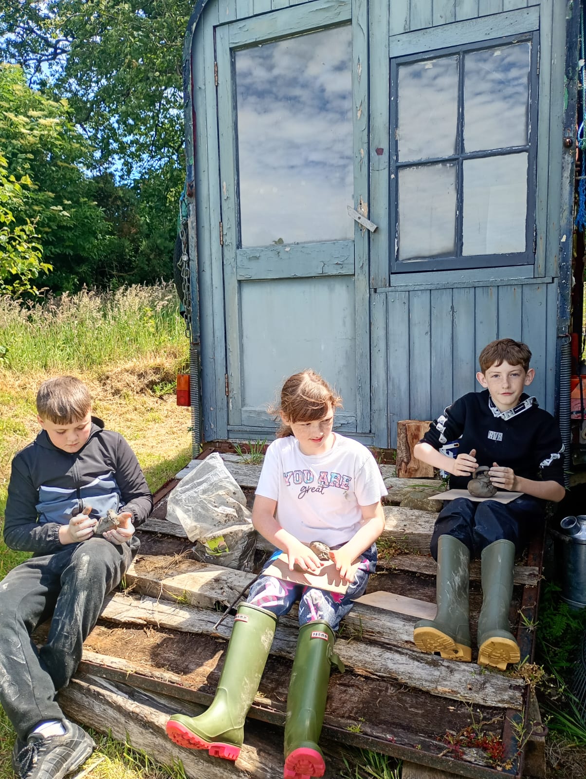 Making clay models on the steps