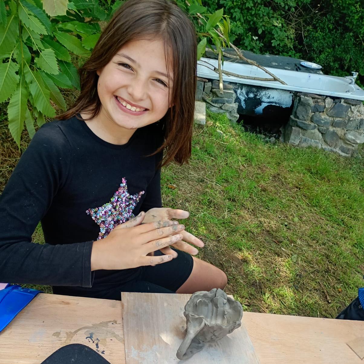 Happy student making clay model