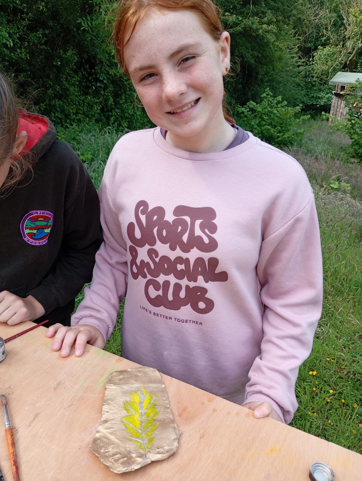Proud student with gold and green leaf