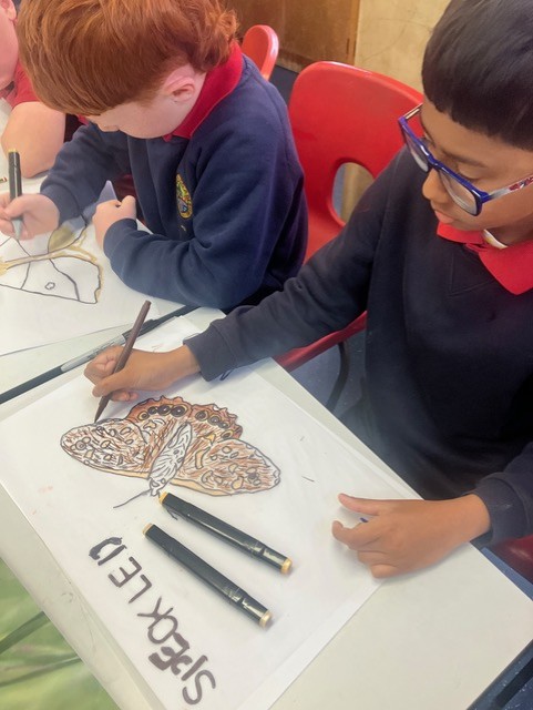 Student colouring the Speckled Wood butterfly