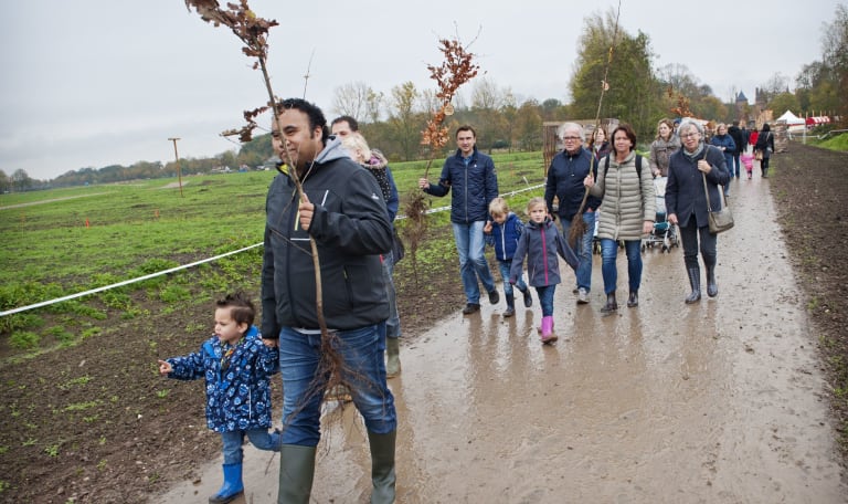 bezoekers planten bomen bij aanleg van Parkbos de Haar