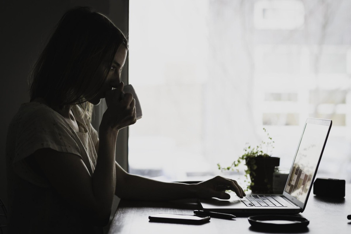 woman drinking coffee and searching the web