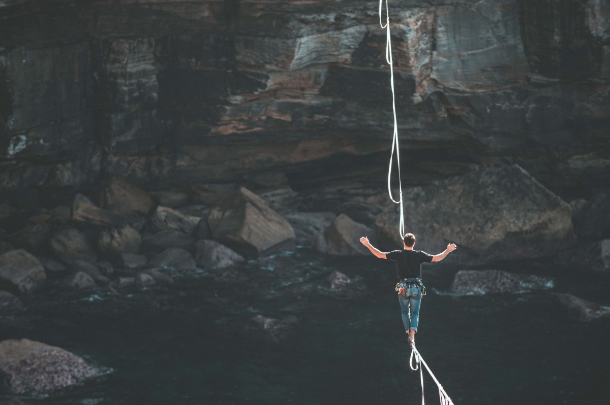 man walking on a tight rope