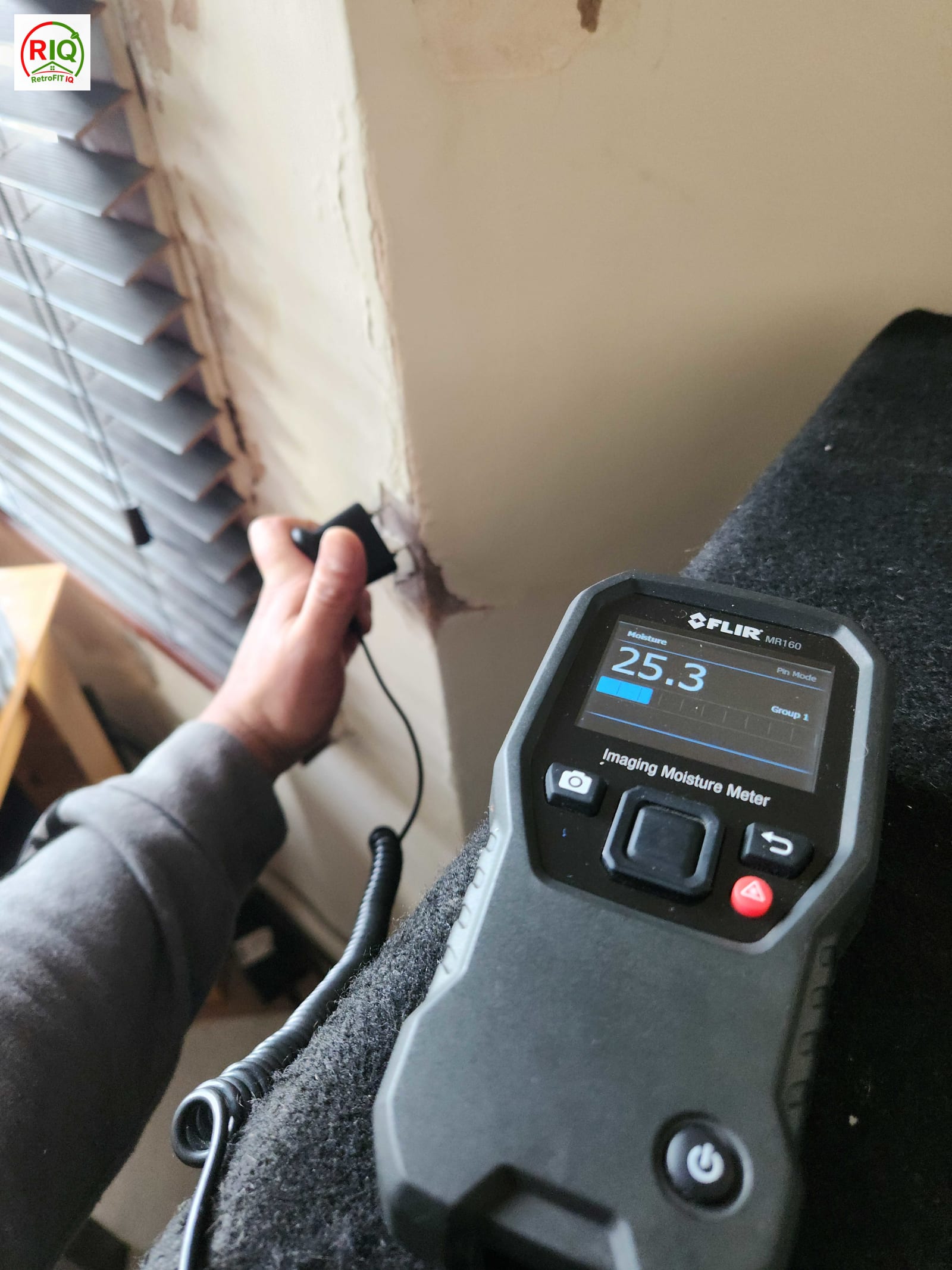 Moisture meter recording elevated readings on a wall consistent with condensation risk