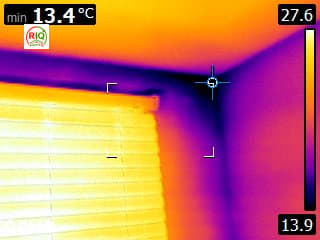 Thermal imaging of a cold wall-to-ceiling corner identified as the main condensation and mould-risk area