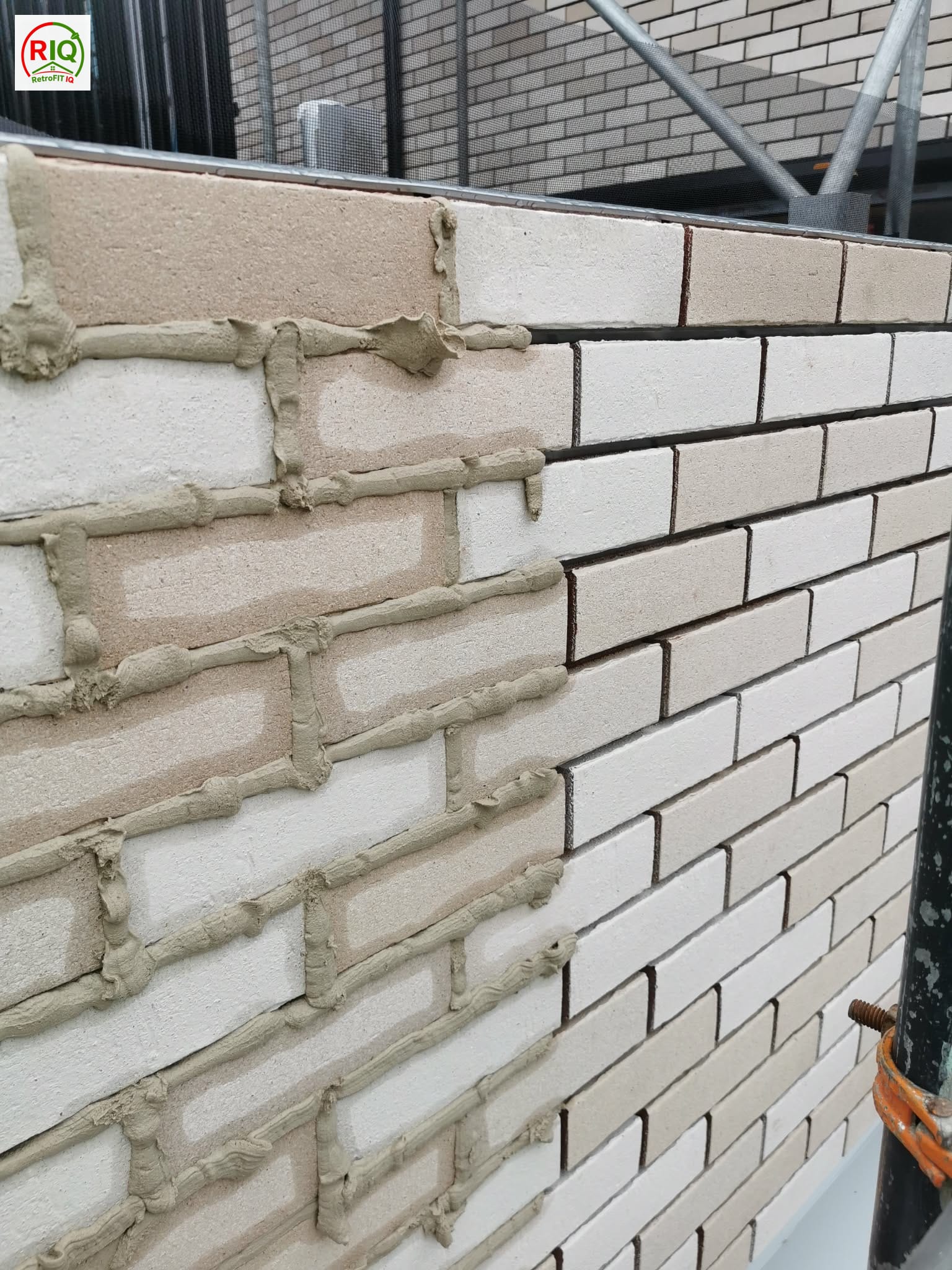 Prefabricated brick-slip cladding panels prepared on site for a ventilated external wall insulation system