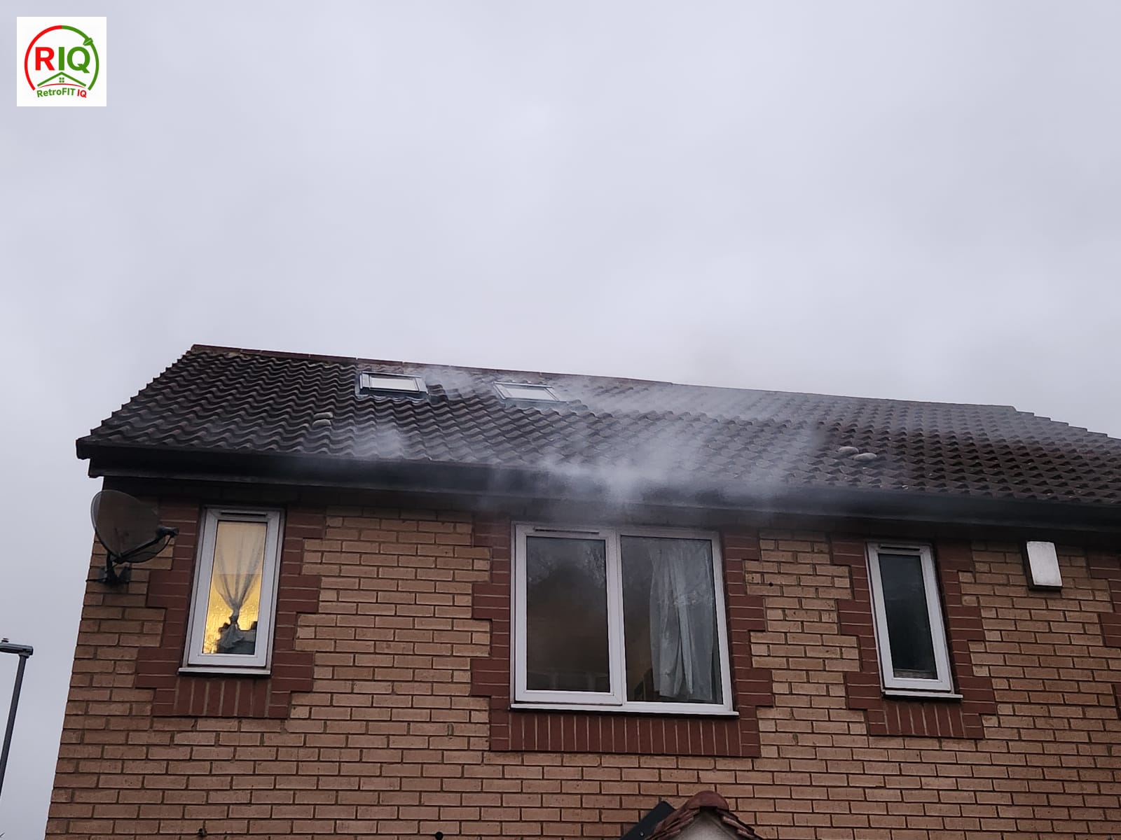 Smoke tracing during a blower door test showing air leakage at the roof eaves — Luton