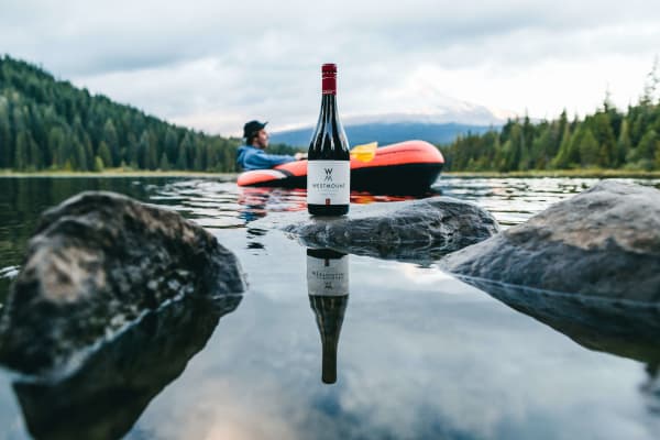 never-better-westmount-wines-man-relaxing-in-tube-with-wine-bottle