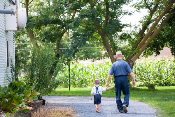 never-better-farmer-focus-grandfather-and-grandson-walking-hand-in-hand