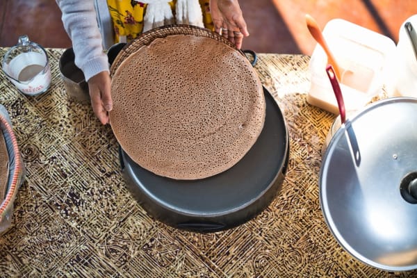 never-better-maskal-teff-making-injera-hands-removing-from-pan