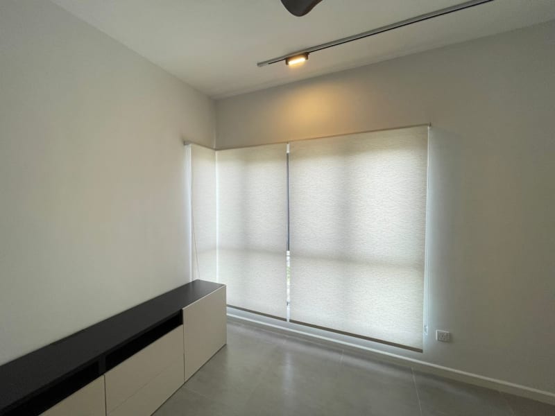 textured light gray roller blinds fully lowered across a bedroom window, softly diffusing daylight from outside