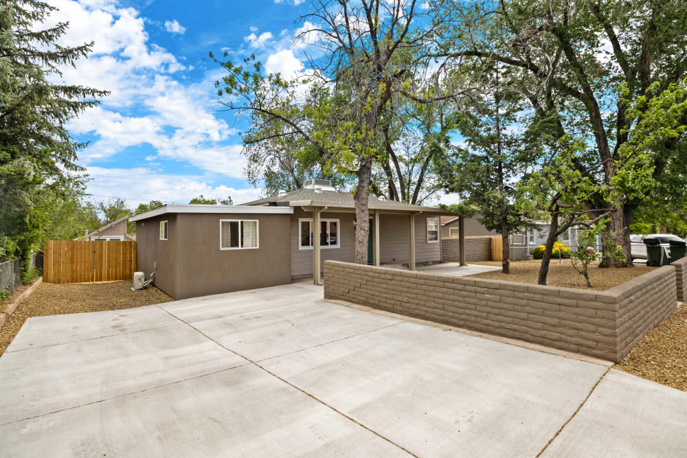 
The exterior of this charming three-bedroom home exudes warmth and appeal. The house features a classic design with a welcoming front porch, perfect for enjoying a morning coffee or evening sunset. The well-maintained façade is complemented by tasteful landscaping, and plenty of parking.