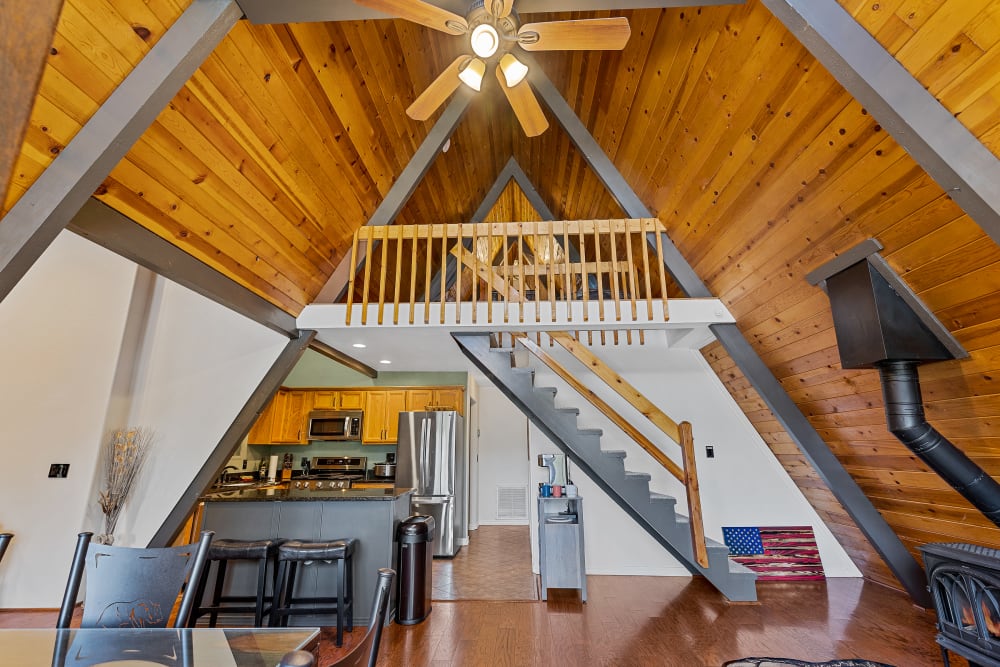 Upper deck front entry with beautiful A-frame wood ceiling, and views of the game room loft