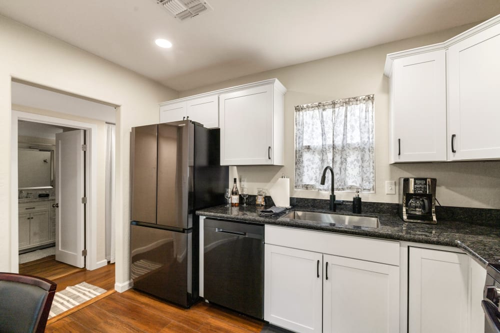 
The remodeled kitchen exudes coziness and functionality, featuring modern amenities. Warm, rich cabinetry pairs beautifully with sleek quartz countertops.