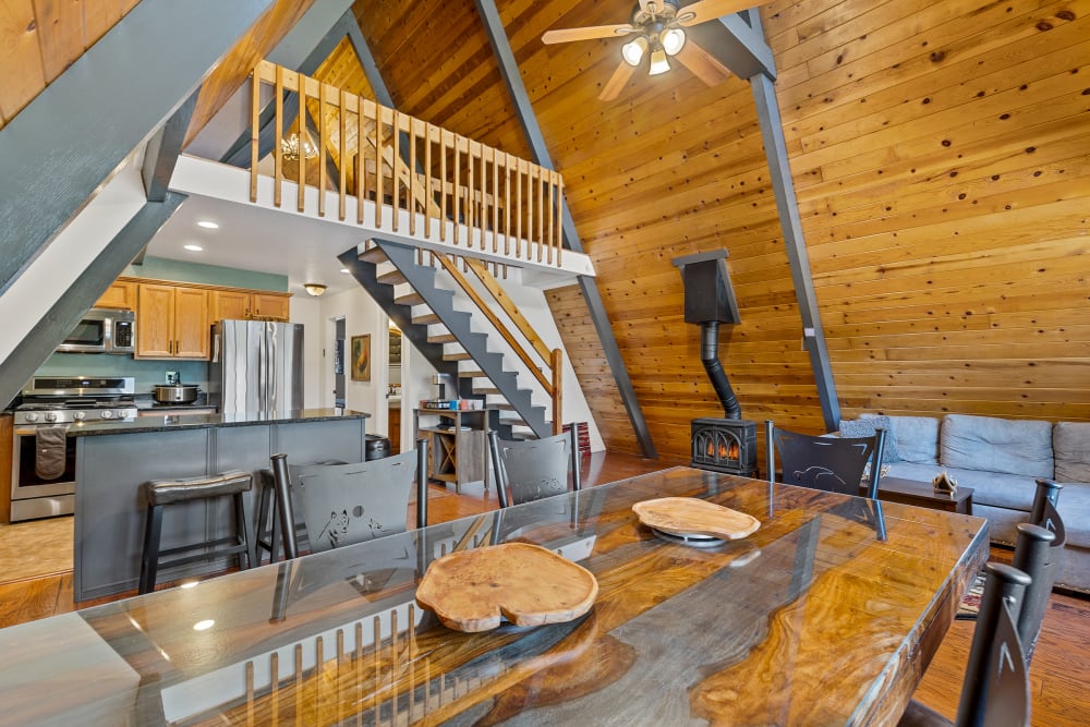 Large Rustic kitchen table- perfect for large meals, gatherings, &  board games on family fun night!

Common area with cozy gas pot belly stove, with  views of kitchen and game room loft!