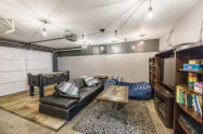 Garage turned Game-Room with foosball table, game table, xl beanbag, 55” Smart TV, many, many games, puzzles, cards, etc. along with a ping pong table