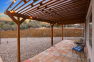 TWO 20 foot long custom pergolas located off each of the queen bedrooms. Perfect for morning coffee, evening wine, or reading a book. Peaceful, fully fenced backyard. 