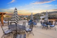Fully fenced backyard patio with plenty of seating for all, while enjoying the breathtaking mountainous views! 
