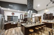 Seating area at custom granite counter surrounding 60” stove. Stoneware dishes and utensils for up to 24 guests, pots & pans for cooking large meals, roaster oven, crockpot, both Keurig & drip coffee makers, grinder, bread maker, etc Just gorgeous!