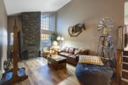 West Wing Living Room with queen pullout sofa, twin pullout sofa chair, 65” Smart TV, X-Large beanbag decorated with prices from local artists. 