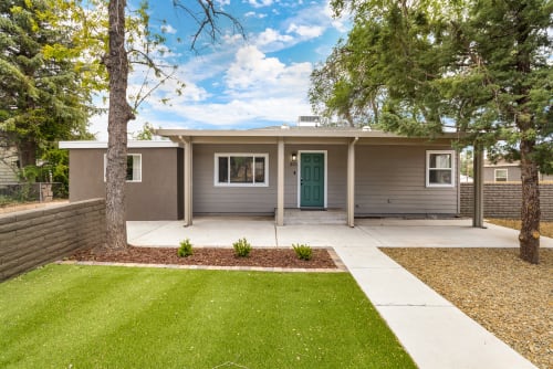 
The exterior of this charming three-bedroom home exudes warmth and appeal. The house features a classic design with a welcoming front porch, perfect for enjoying a morning coffee or evening sunset. The well-maintained façade is complemented by tasteful landscaping.