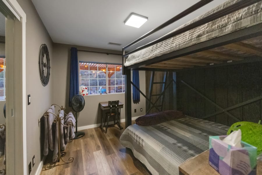 Bedroom #3 located in the East-wing with Queen over Queen industrial strength bunk beds, desk/work space,  black-out curtains, closet with full length mirror doors. 