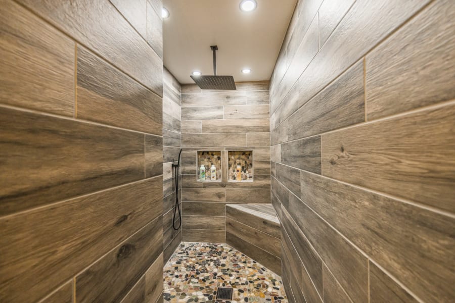 Walk in DREAM wood tile and rock floor walk-in RAIN shower located in West-side King Master Bedroom! Did I mention the tankless water heaters for extra long showers and hot water for everyone. There are TWO of these showers in this amazing home! 