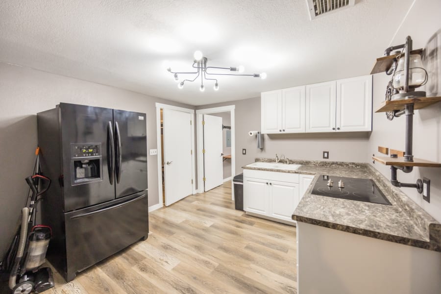 Kitchenette located right off of the garage turned game room. 