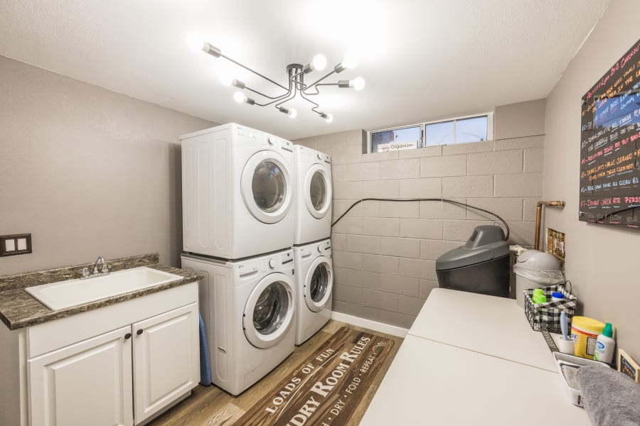 Laundry room has TWO sets of stacking washers and dryers, laundry room sink, 6' folding table, and enough detergent, softener, dryer sheets, provided for your first few loads of laundry. 