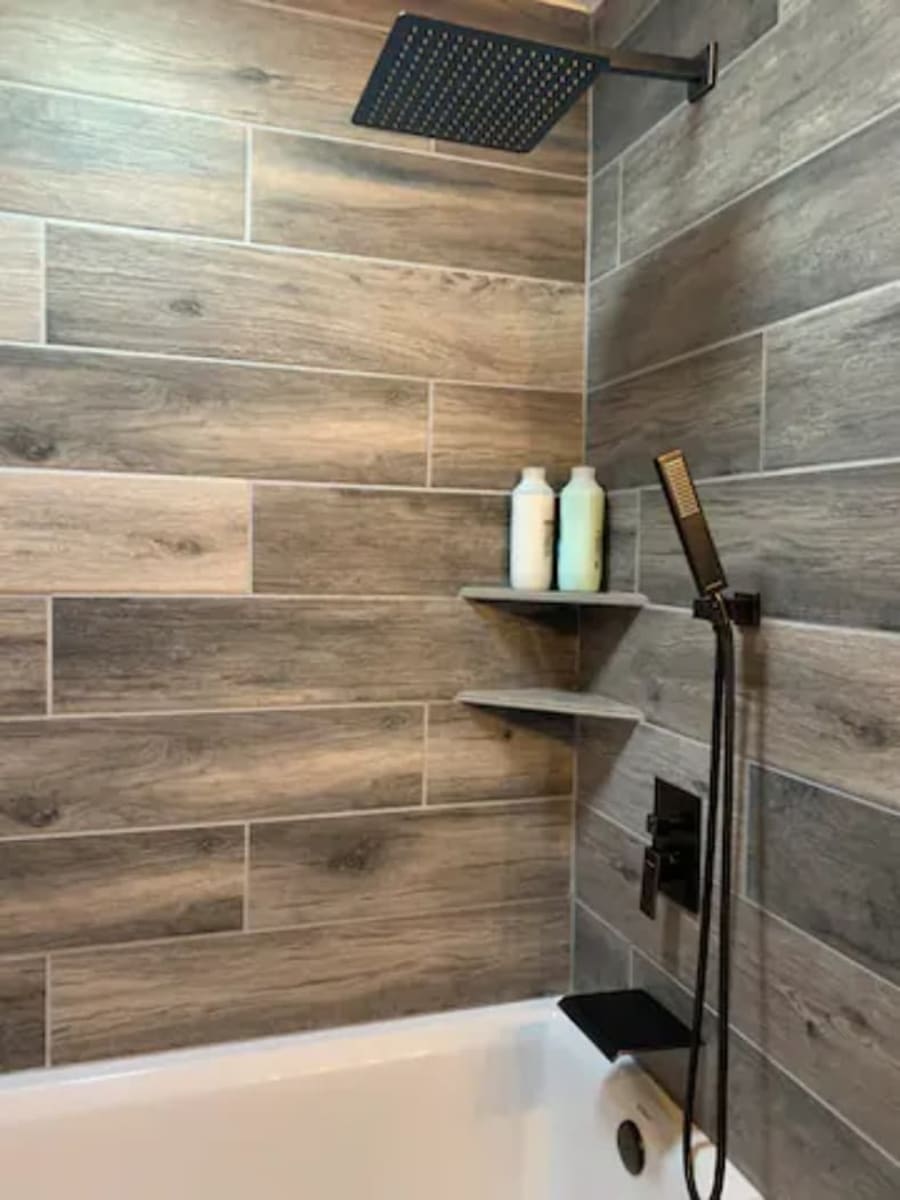 Bathrooms have deep tubs, custom tile, rain shower heads and hand held shower heads. 