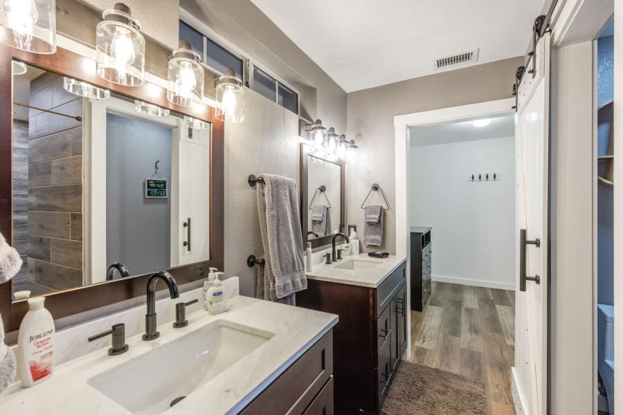 Bathroom #1, East-wing Master Bedroom bathroom with double vanity sinks that leads into walk-in closet, private area soft-close toilet room, and spectacular walk-in rain shower. 