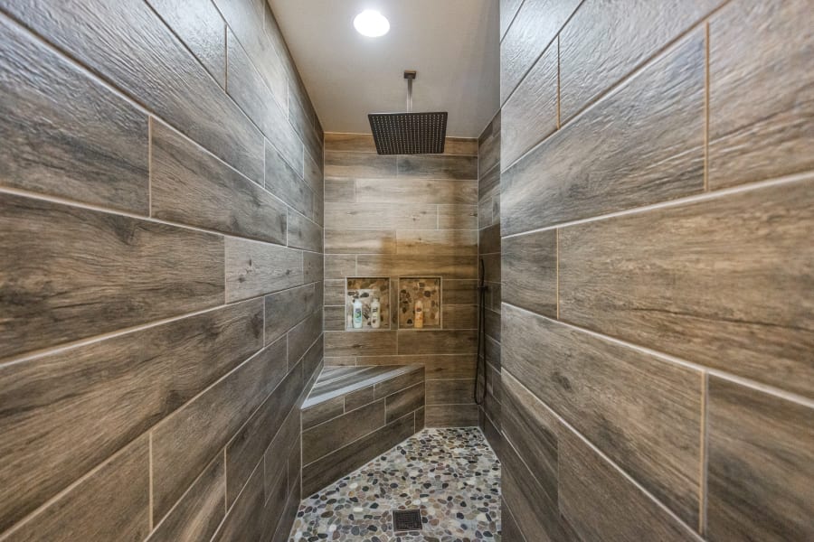 Walk in DREAM wood tile and rock floor walk-in RAIN shower located in West-side King Master Bedroom! Did I mention the tankless water heaters for extra long showers and hot water for everyone. There are TWO of these showers in this amazing home! 