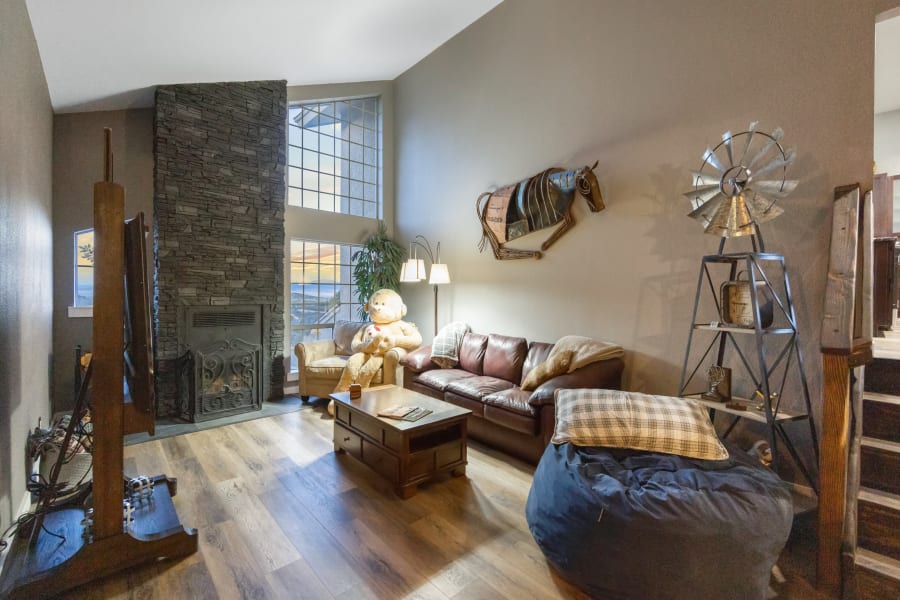West Wing Living Room with queen pullout sofa, twin pullout sofa chair, 65” Smart TV, X-Large beanbag decorated with prices from local artists. 